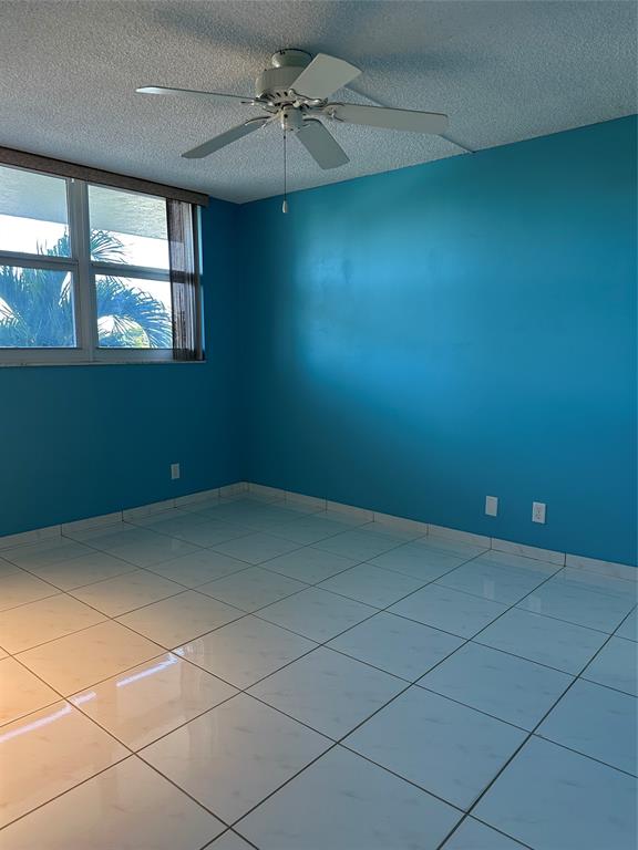 5300 Northeast 24th Terrace, Unit 211C Fort Lauderdale, FL 33308 - Photo 12 of 23 a view of an empty room with windows