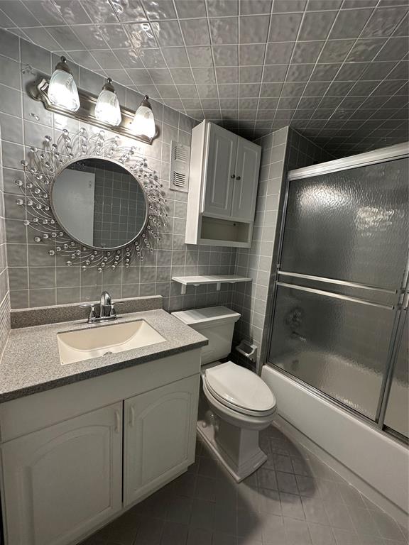 5300 Northeast 24th Terrace, Unit 211C Fort Lauderdale, FL 33308 - Photo 15 of 23 a bathroom with a granite countertop sink a toilet and a mirror