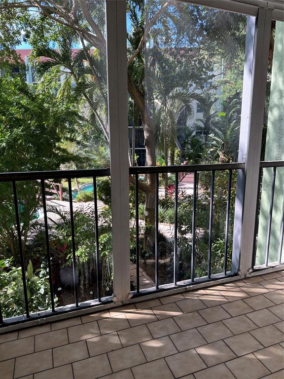 5300 Northeast 24th Terrace, Unit 211C Fort Lauderdale, FL 33308 - Photo 16 of 23 a view of a door and chair in the balcony