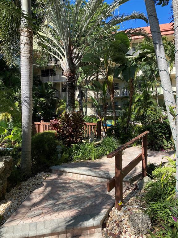 5300 Northeast 24th Terrace, Unit 211C Fort Lauderdale, FL 33308 - Photo 19 of 23 a view of a bench in a yard