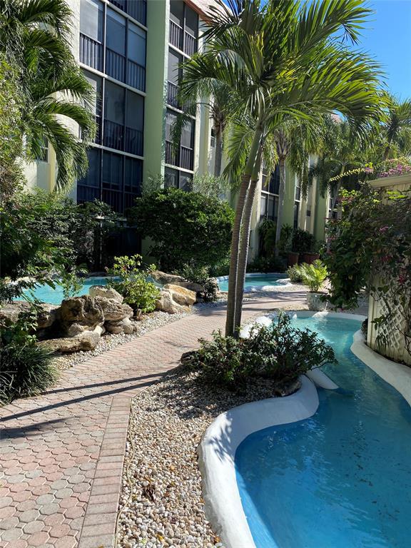 5300 Northeast 24th Terrace, Unit 211C Fort Lauderdale, FL 33308 - Photo 20 of 23 a view of a yard with plants and trees