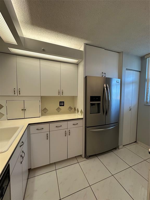 5300 Northeast 24th Terrace, Unit 211C Fort Lauderdale, FL 33308 - Photo 4 of 23 a kitchen with a sink and refrigerator