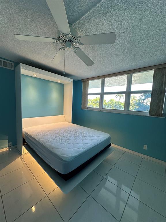 5300 Northeast 24th Terrace, Unit 211C Fort Lauderdale, FL 33308 - Photo 10 of 23 a bedroom with a bed and window