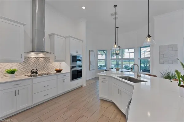 a view of a dining room with furniture large windows and wooden floor