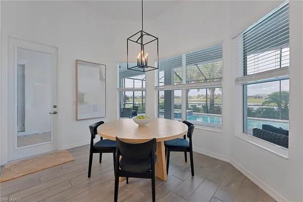 a bathroom with a tub double sink window and mirror