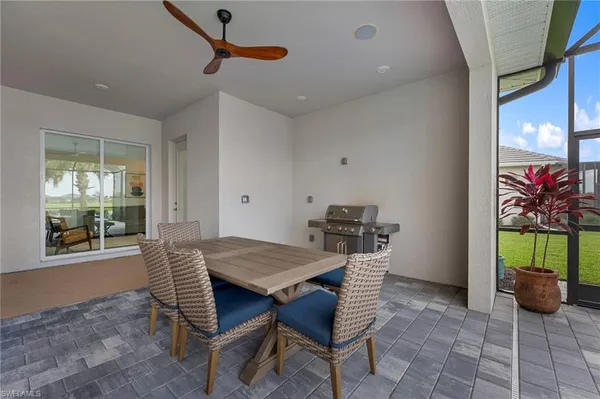 a living room with furniture chandelier and a large window