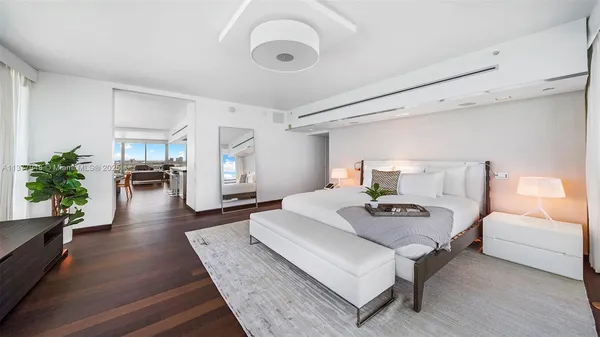 a living room with furniture and large windows