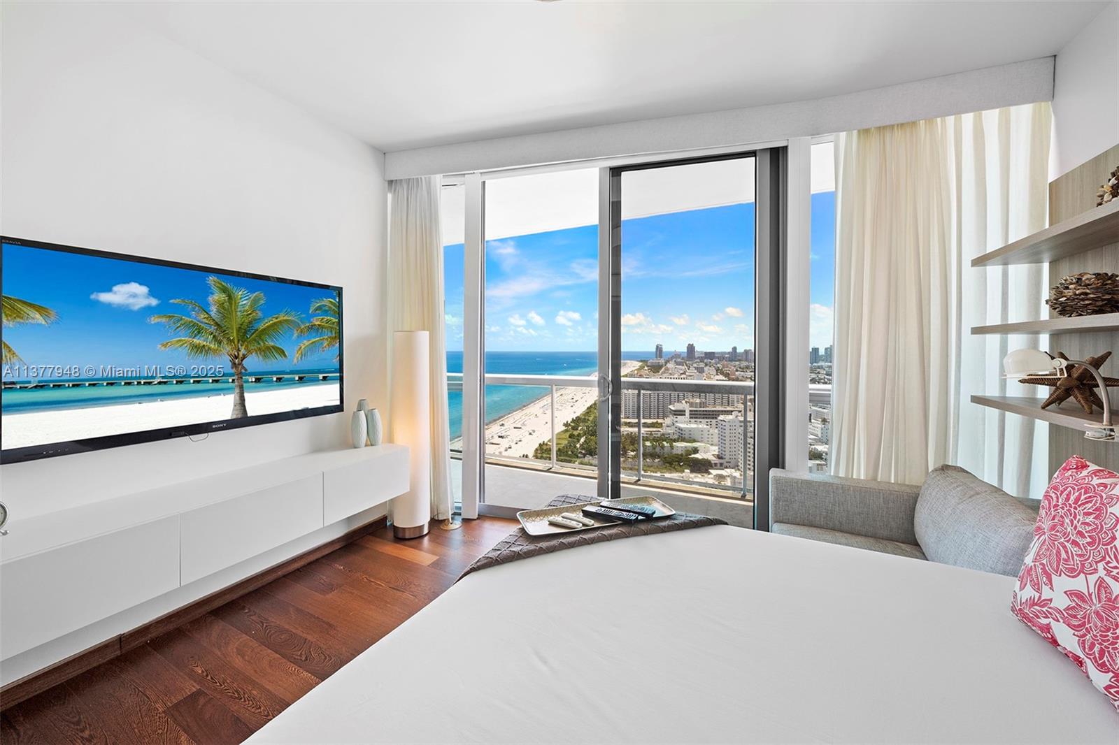 101 20th Street, Unit 3909 Miami Beach, FL 33139 - Photo 51 of 61 a bedroom with large window and a bed