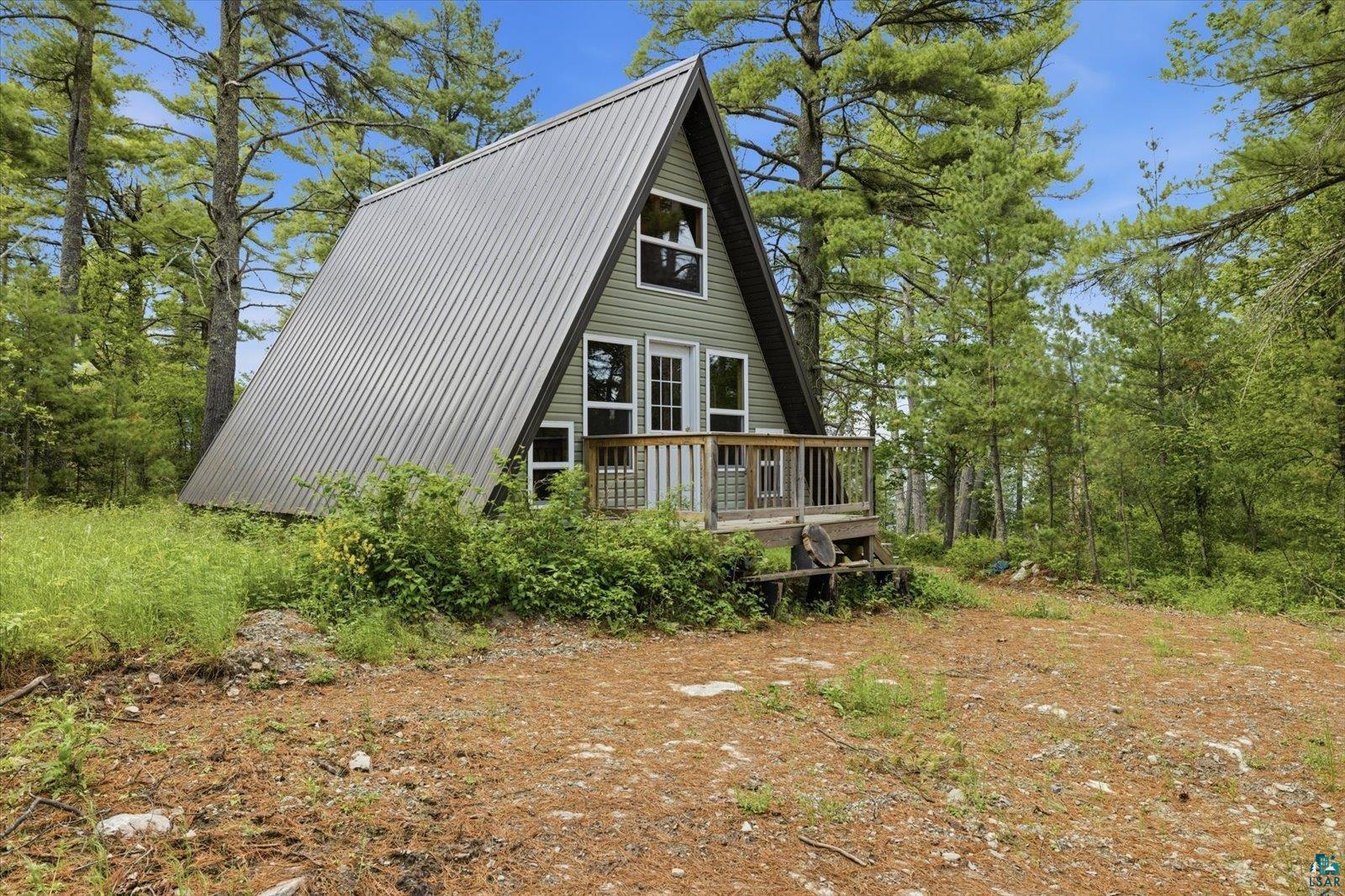 5298 Long Island Tower, MN 55790 - Photo 2 of 31 A-frame residence featuring a metal roof and light green siding