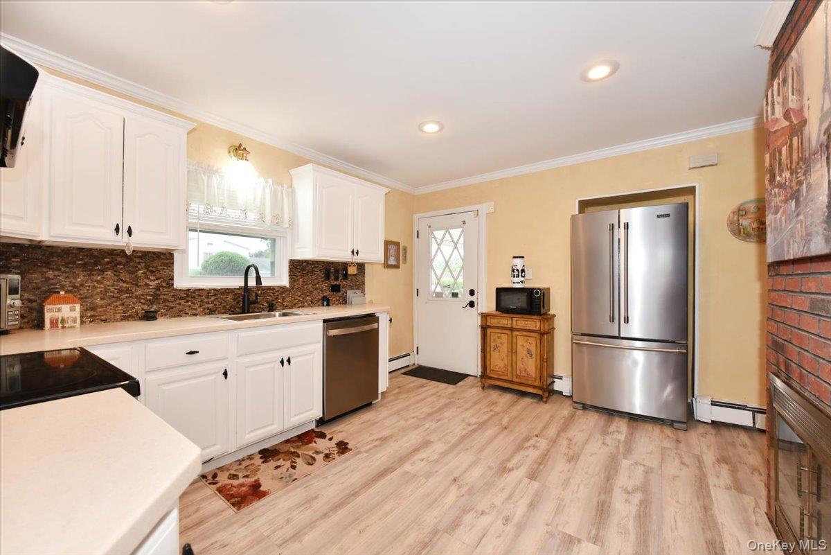 307 Blacksmith Road Levittown, NY 11756 - Photo 13 of 27 a kitchen with granite countertop a refrigerator stove top oven and sink