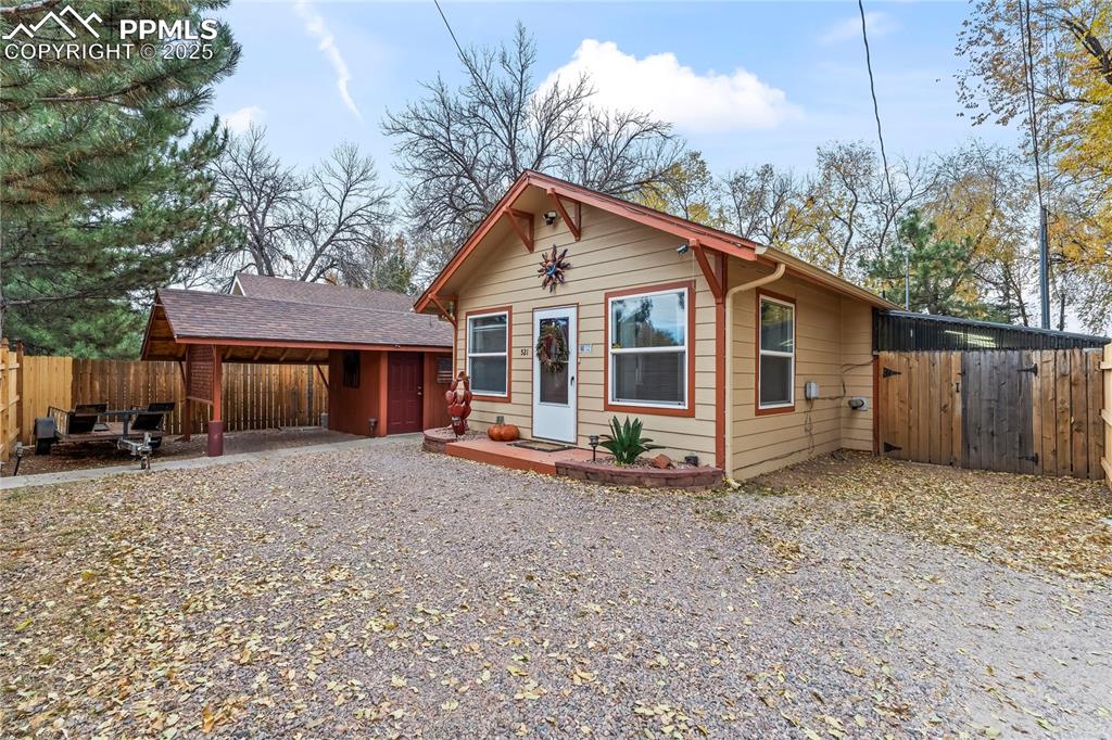 521 Brookside Street Colorado Springs, CO 80905 - Photo 2 of 27 a view of a house with a yard and wooden fence