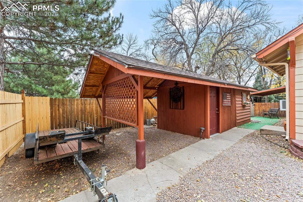 521 Brookside Street Colorado Springs, CO 80905 - Photo 21 of 27 a backyard of a house with barbeque oven table and chairs