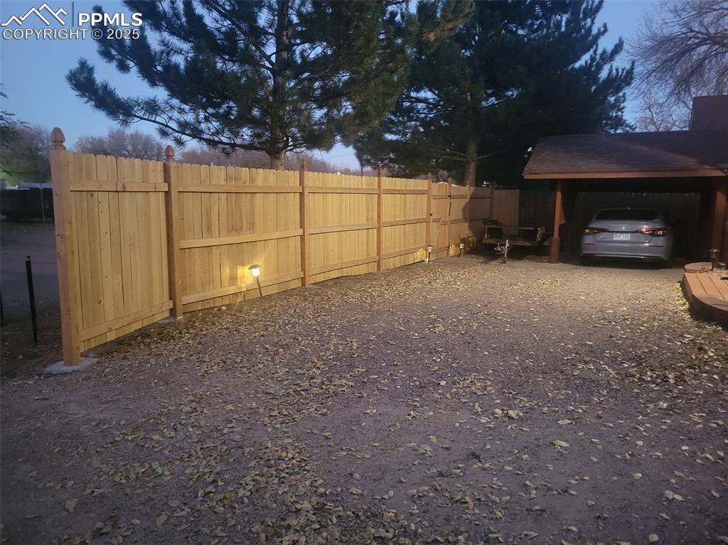 521 Brookside Street Colorado Springs, CO 80905 - Photo 23 of 27 a view of a car garage and a car parked in a yard