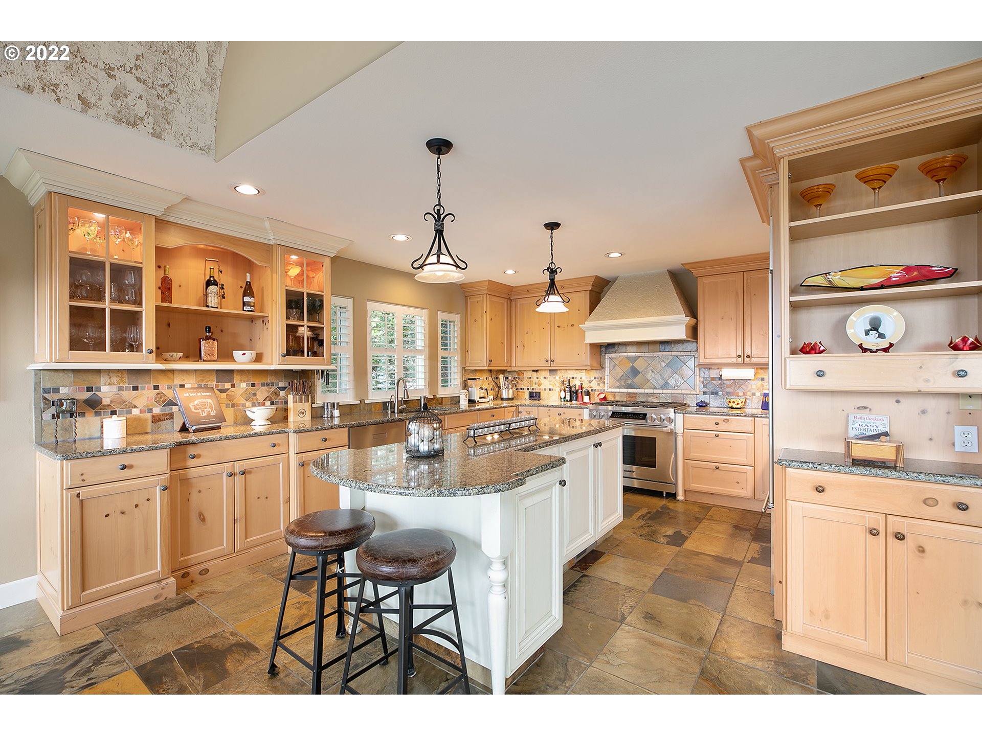 4027 Northwest Devoto Lane Portland, OR 97229 - Photo 15 of 48 a kitchen with stainless steel appliances kitchen island granite countertop a sink and cabinets