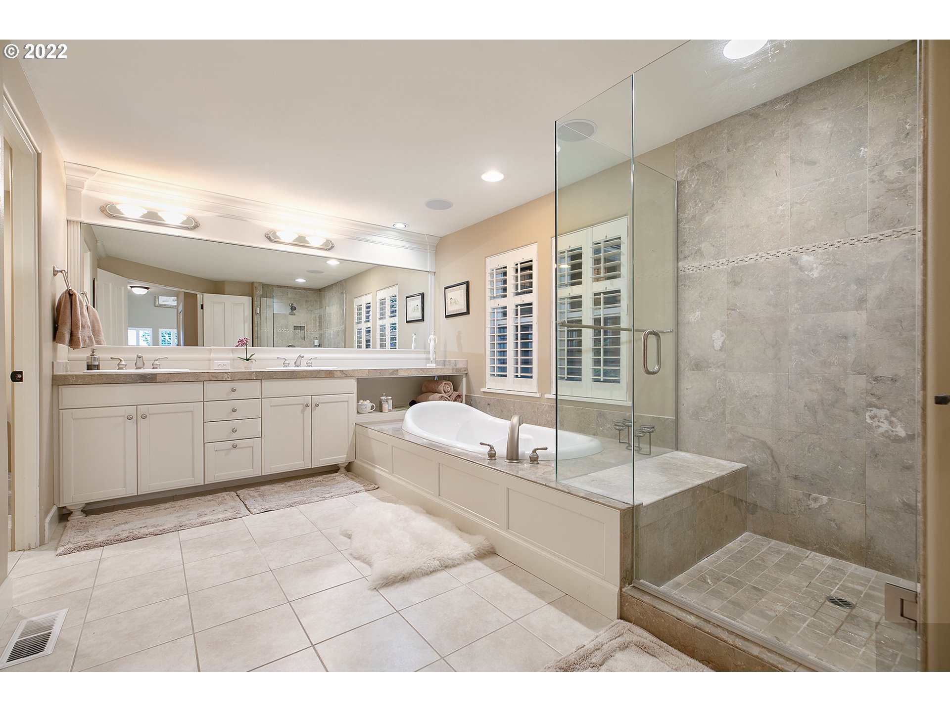 4027 Northwest Devoto Lane Portland, OR 97229 - Photo 17 of 48 a spacious bathroom with a tub sink shower and mirror