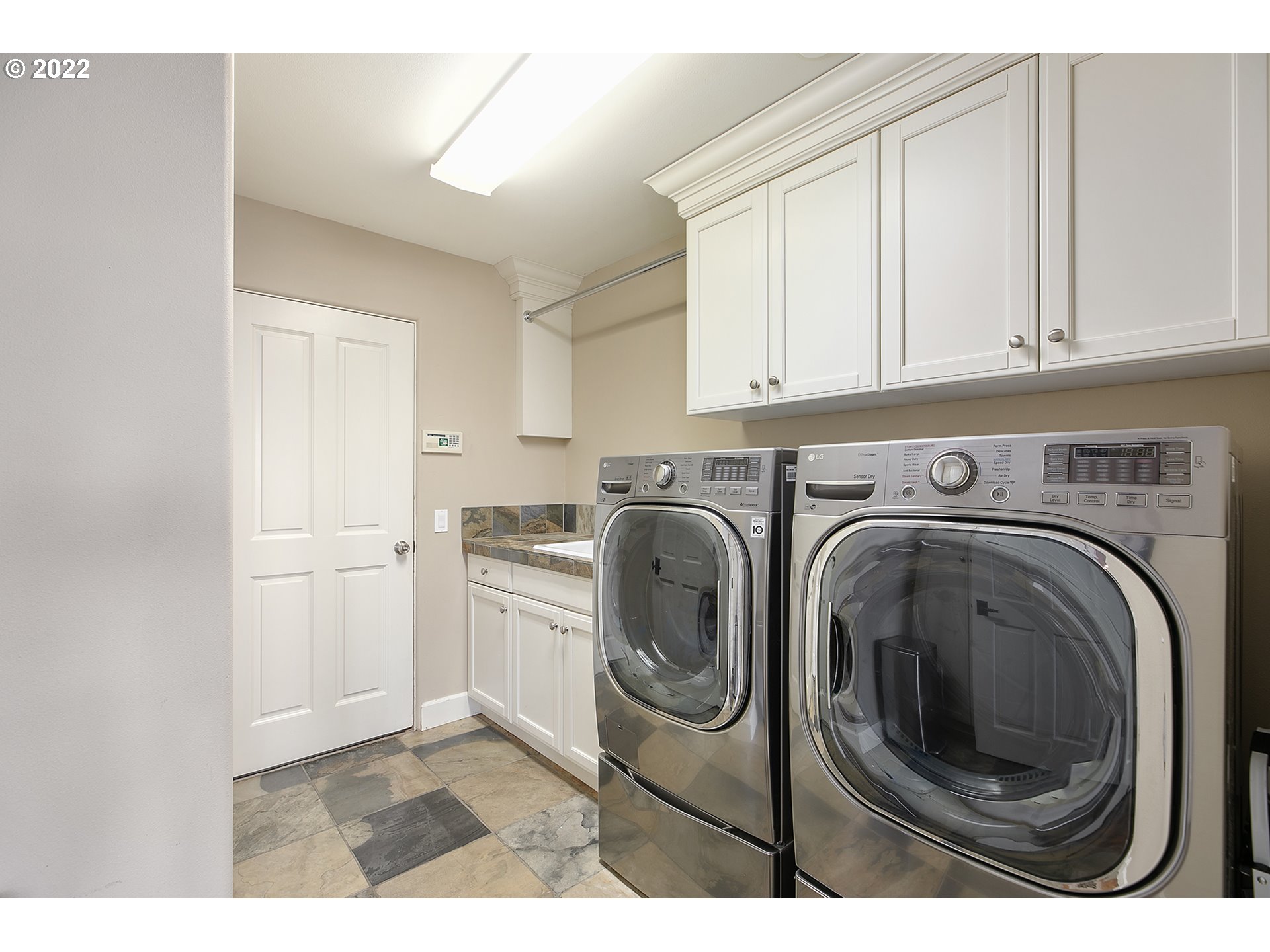 4027 Northwest Devoto Lane Portland, OR 97229 - Photo 22 of 48 a utility room with sink dryer and washer