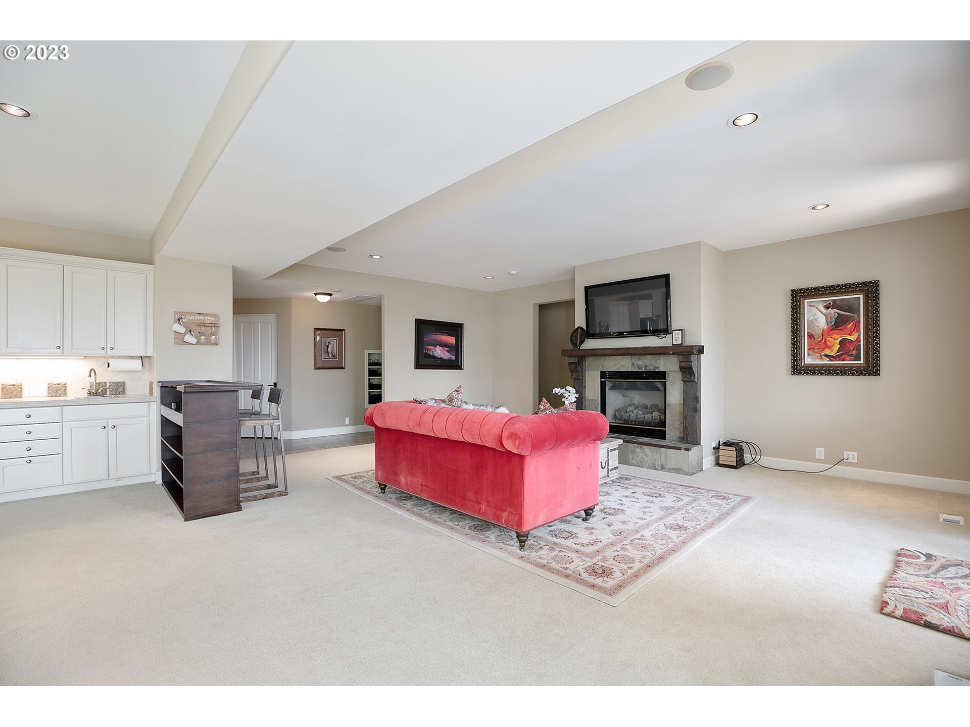 4027 Northwest Devoto Lane Portland, OR 97229 - Photo 32 of 48 a living room with furniture flat screen tv and a fireplace