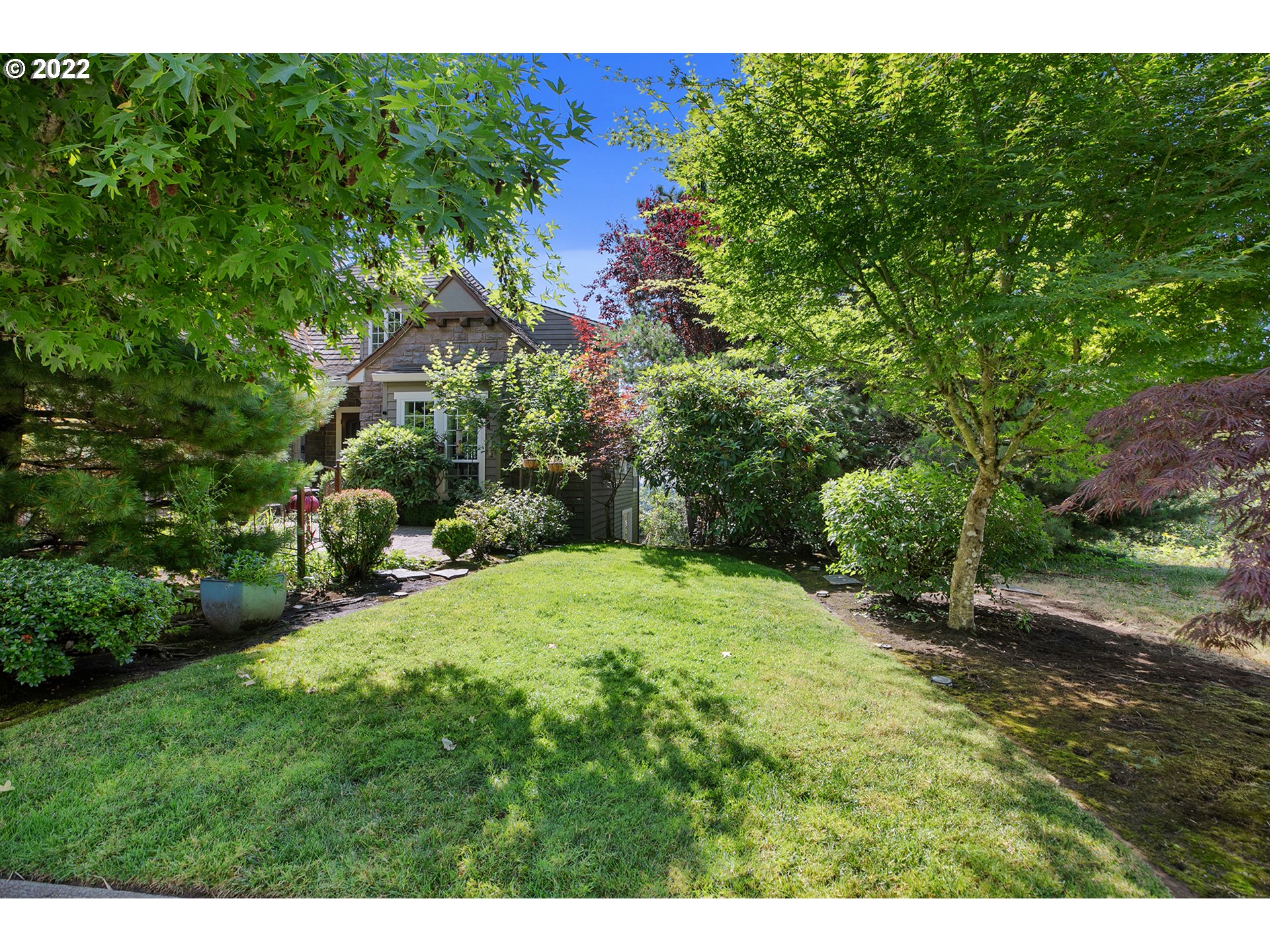 4027 Northwest Devoto Lane Portland, OR 97229 - Photo 5 of 48 a backyard of a house with a garden and plants