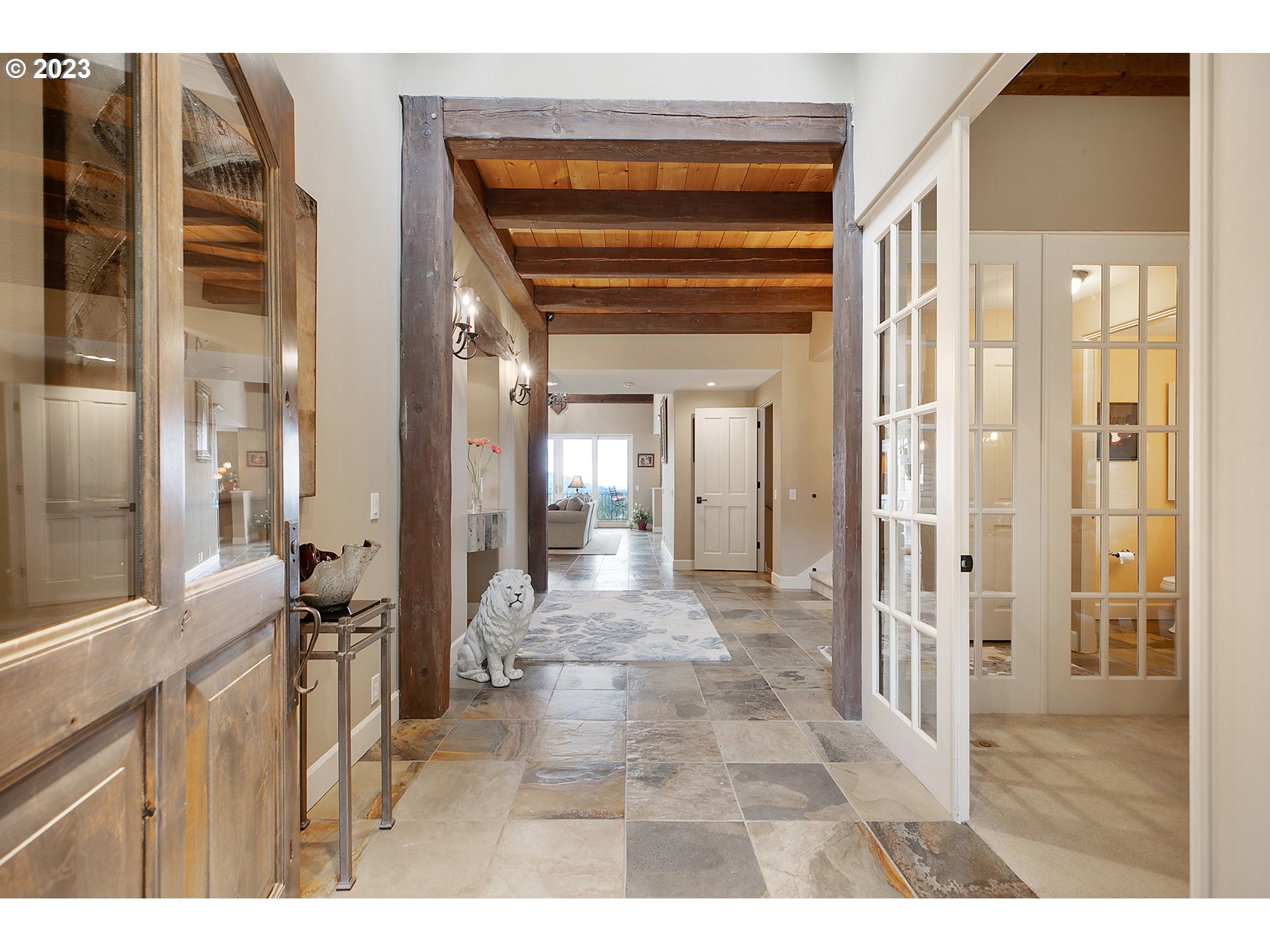 4027 Northwest Devoto Lane Portland, OR 97229 - Photo 48 of 48 a view of a hallway with a dining table and chandelier