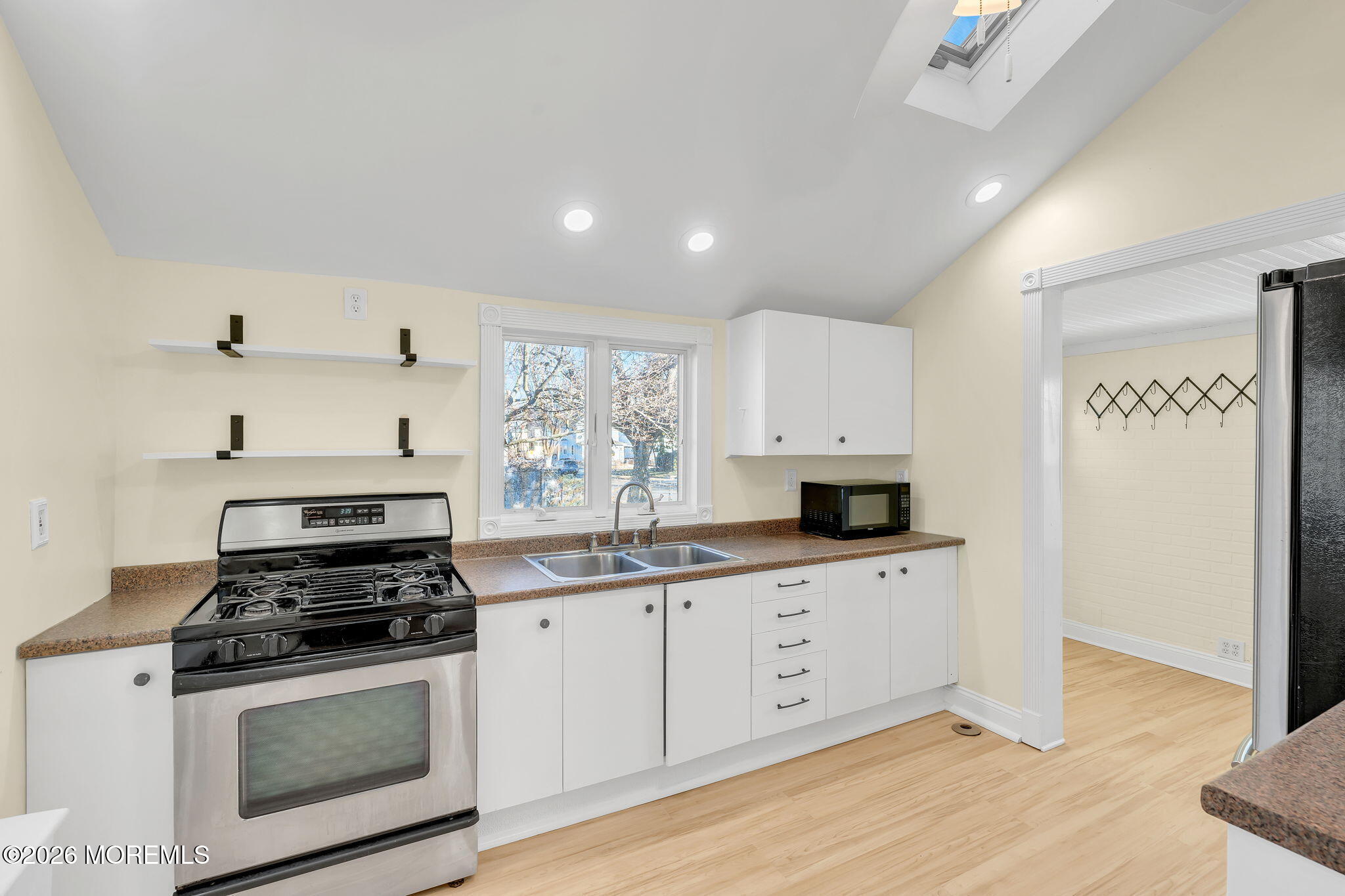 104 Bank Street Red Bank, NJ 07701 - Photo 7 of 16 a kitchen with granite countertop a sink stainless steel appliances and cabinets