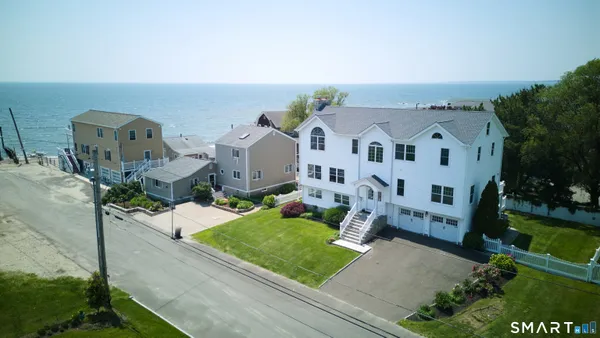 an aerial view of a house with a yard