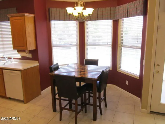 a living room with furniture a lamp and a flat screen tv