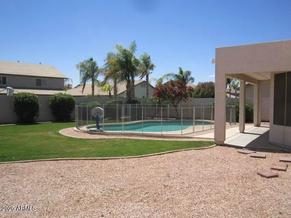 a view of a house with backyard and sitting area