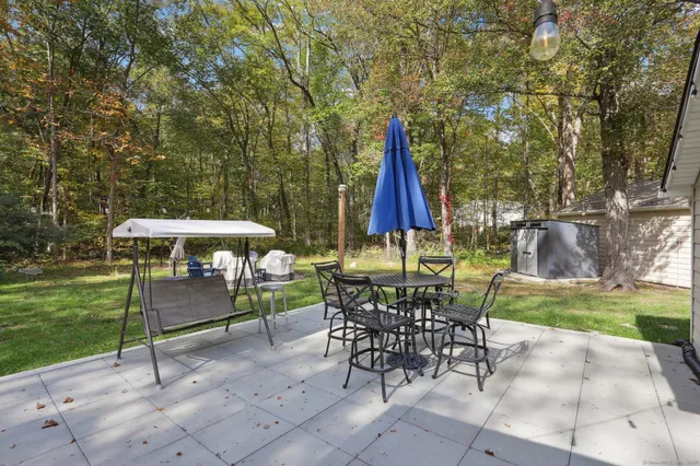 a view of a tables and chairs under an umbrella