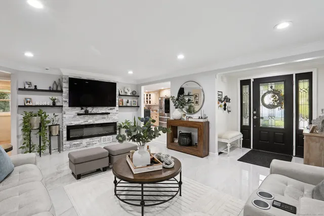 a living room with furniture a fireplace and a flat screen tv