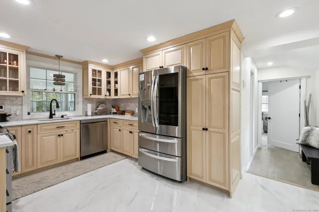 a kitchen with a refrigerator and a sink