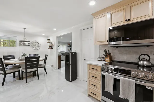 a kitchen with stainless steel appliances a stove a sink and a microwave