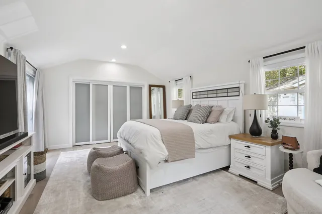 a living room with furniture large window and flat screen tv