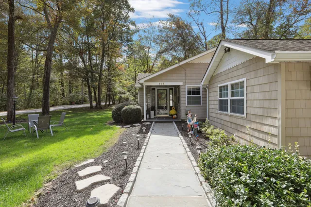 a view of a house with backyard sitting area and garden