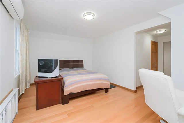 a bedroom with a bed and a television