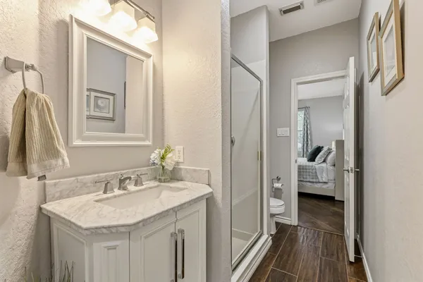 a en suite bathroom with a sink a mirror and a shower