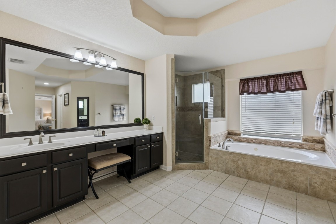 20102 Windbury Court Spring, TX 77379 - Photo 22 of 49 The beautiful tray ceilings are displayed in the primary bathroom, as well.