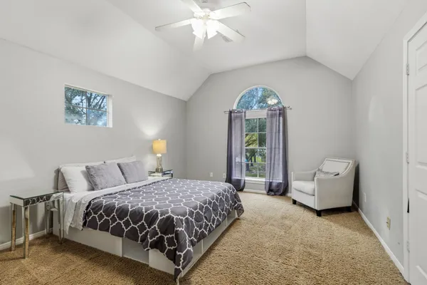 a bedroom with a bed and a chandelier