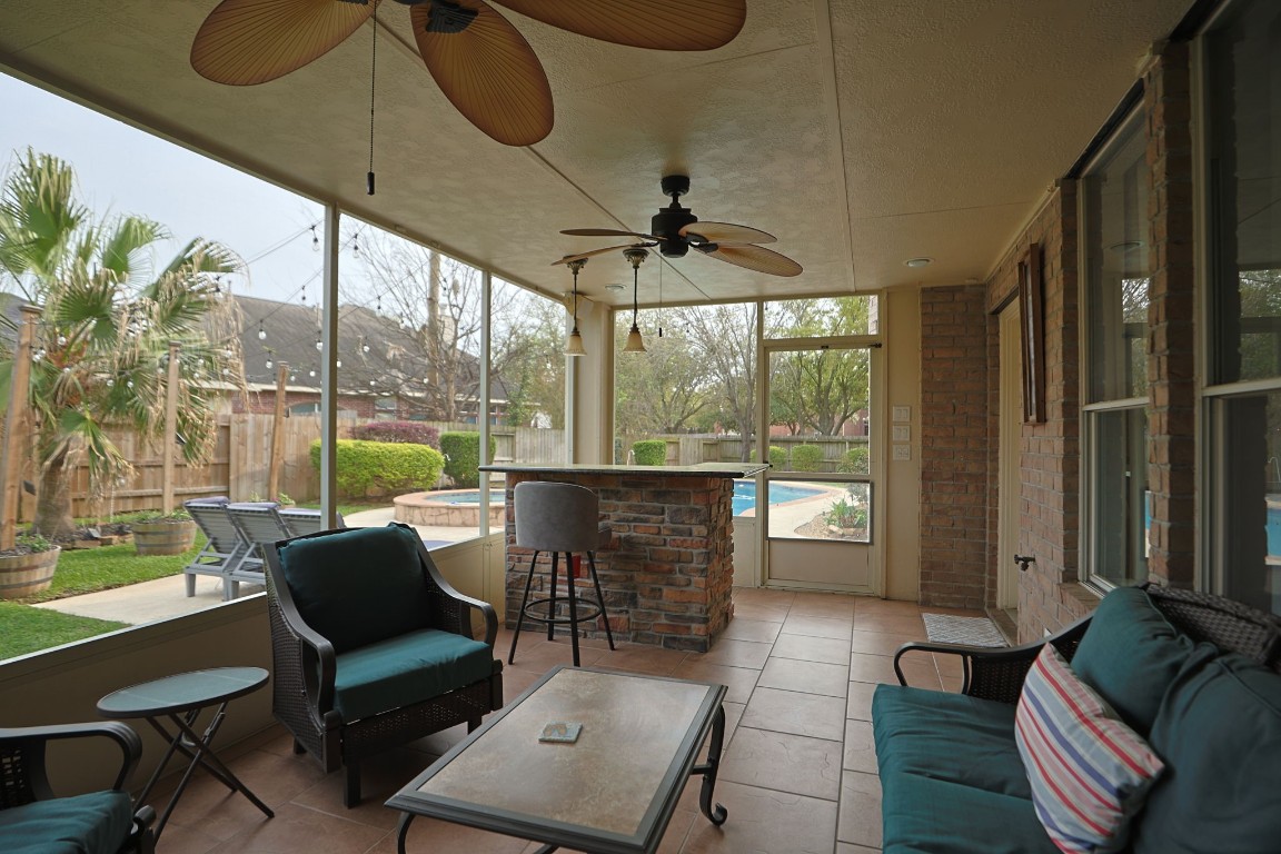 20102 Windbury Court Spring, TX 77379 - Photo 28 of 49 The covered, screened in patio looks out onto the pool and has a beverage and snack bar.