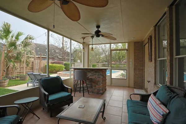 a living room with furniture and a floor to ceiling window