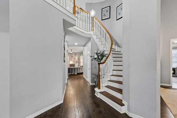 a view of entryway and hall with wooden floor