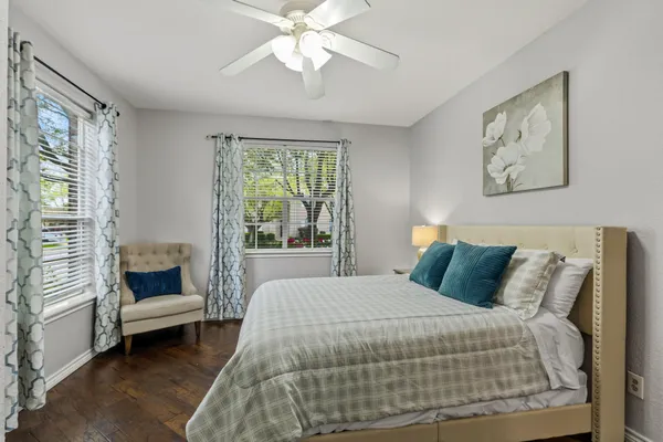 a bedroom with a large bed and a chandelier