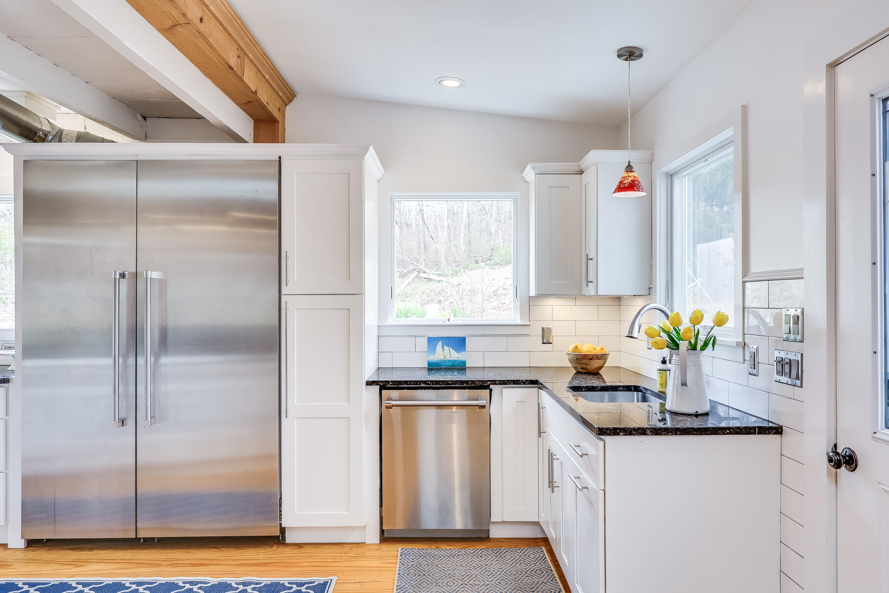 2147 Route 6 Wellfleet, MA 02667 - Photo 27 of 98 a kitchen with stainless steel appliances a sink a refrigerator a counter top space cabinets and a window
