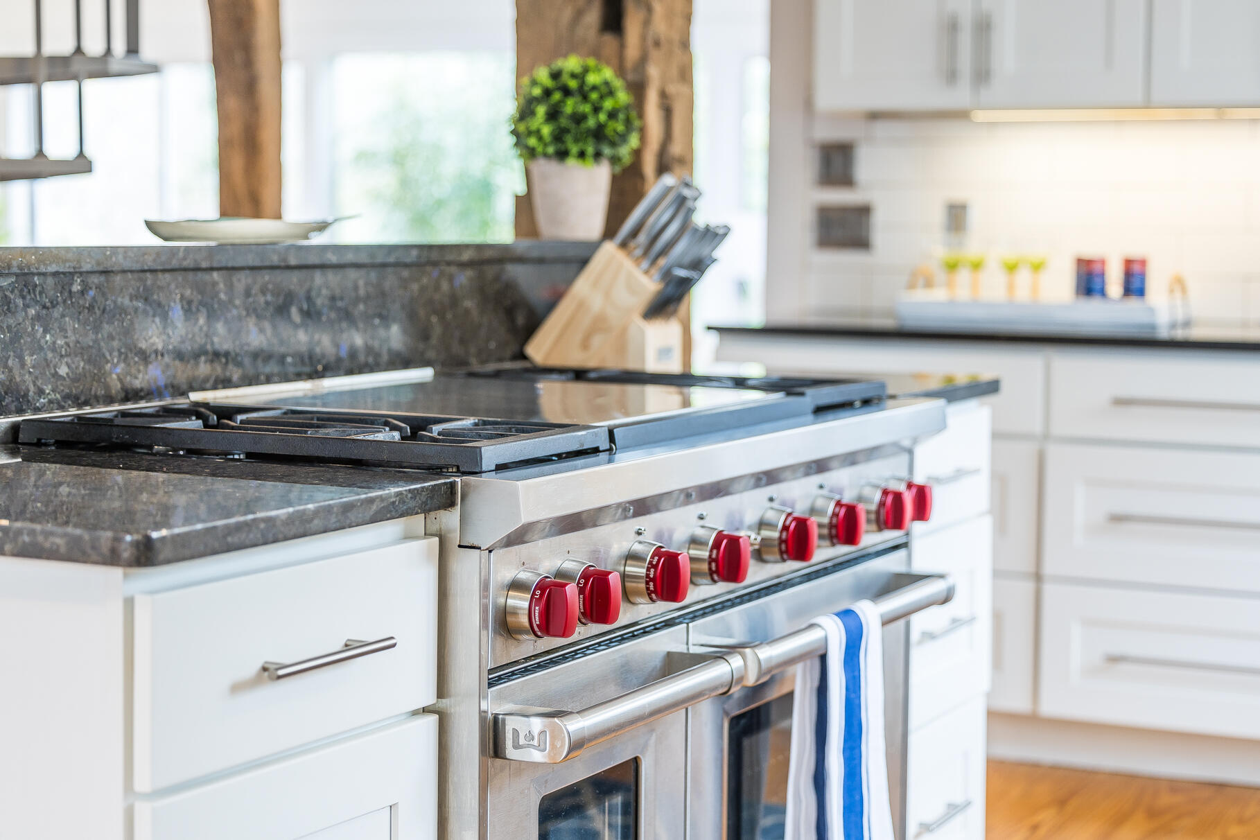 2147 Route 6 Wellfleet, MA 02667 - Photo 32 of 98 a kitchen with a stove and a white wooden cabinets