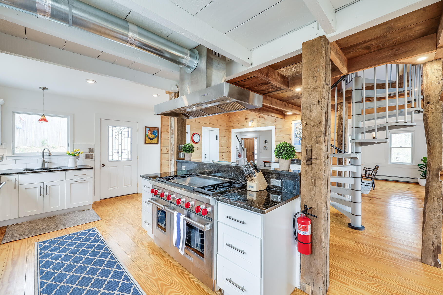 2147 Route 6 Wellfleet, MA 02667 - Photo 37 of 98 a kitchen with stainless steel appliances granite countertop a stove and a wooden floors