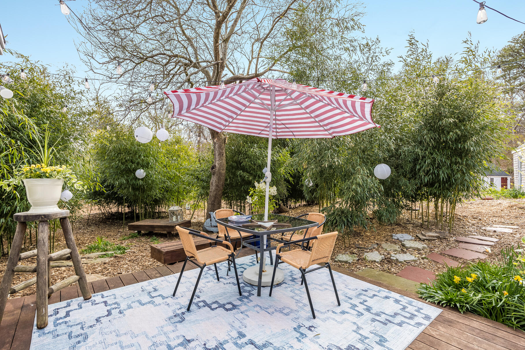 2147 Route 6 Wellfleet, MA 02667 - Photo 88 of 98 a view of a backyard with table and chairs and potted plants