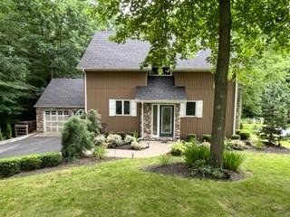 a front view of a house with a yard and outdoor seating