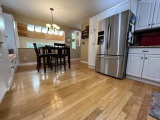 45 Willadell Road Transfer, PA 16154 - Photo 10 of 29 a kitchen with stainless steel appliances granite countertop a refrigerator a stove a dining table and chairs with wooden floor