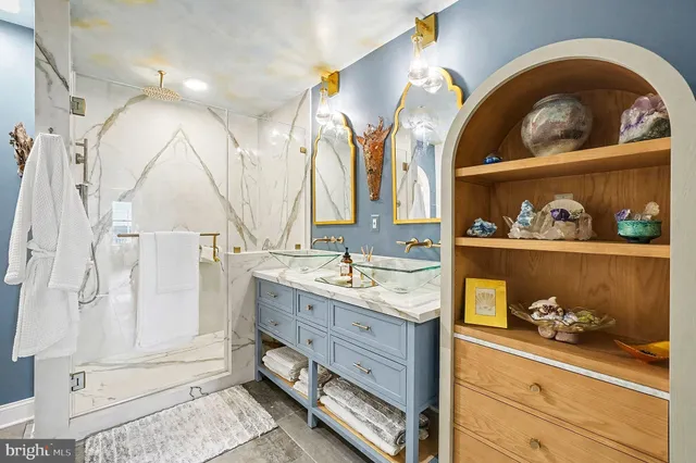 a spacious bathroom with a granite countertop sink mirror and shower