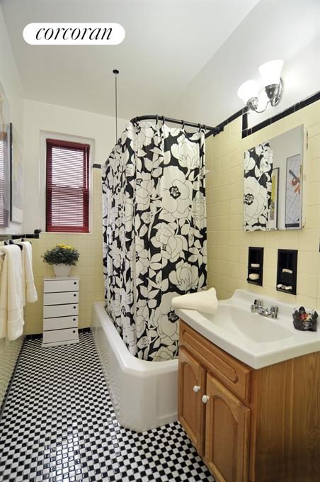a bathroom with a sink a toilet and shower curtain