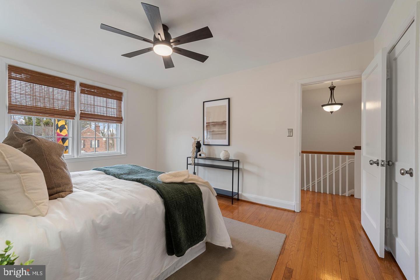 183 Stanmore Road Baltimore, MD 21212 - Photo 15 of 32 a bedroom with a bed and dresser with wooden floor